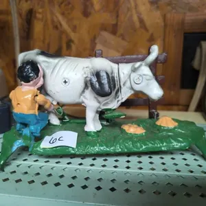 Cast iron kicking, milking cow bank