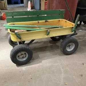 Yellow wagon with green wood sideboards.  Broken