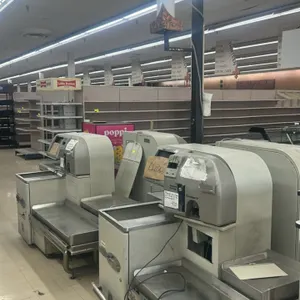 Fujitsu U-Scan metal self-checkout registers. Features stainless steel bagging decks, coin/cash acceptors, and coupon slots. Note: Sold for parts or r