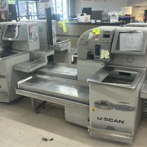 Fujitsu U-SCAN self-checkout station. Features metal construction with stainless steel bagging decks, cash and coin acceptors, and integrated display 
