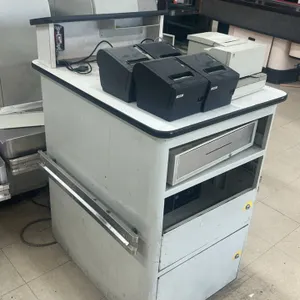 Laminate reception stand. Features a white laminate finish, raised privacy shelf, built-in metal cash drawer, and two lower locking cabinets. Includes