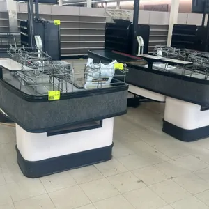 Load King single belt checkout lane. Features a motorized conveyor belt, integrated bagging racks, and cashier stand. Dimensions: 141"L x 48"W. Note: 