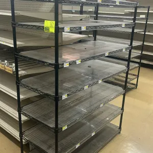 Metro 7-tier wire shelving rack. Features black epoxy-coated steel construction and includes clear plastic shelf liners. 48"W x 21"D x 65"H. Mounted o