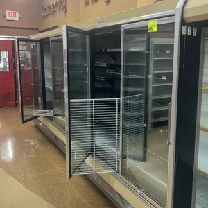 1995 Hussmann RCA3L U 5-door glass door frozen food display case. Features solid black shelves and bottom wire racks. S/N: 9908-3311. Electrical: 208V