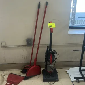 Bissell CleanView Compact upright bagless vacuum cleaner. Features a corded design with a clear dirt canister and attachment nozzle. Includes (2) red 