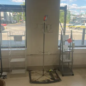 Assorted retail merchandisers. Package lot of (5) display fixtures. Includes (1) black metal flag display rack on casters, (1) white wire 3-shelf disp