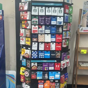 Gift Card Mall branded 3-sided card merchandiser. Features three pegboard display sides with metal peg hooks and a top header sign reading 'Great gift
