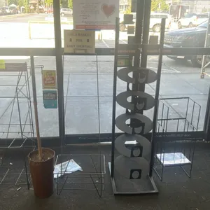 Assorted metal merchandisers. Includes a Louisville Eccentric Observer wire newspaper rack, a 5-tier circular metal disc display stand, a wire sign ho