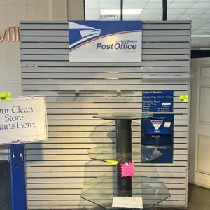 Unbranded 7' x 8' slatwall display partition. Features a grey finish with horizontal grooved slats. Includes a mounted United States Post Office Contr