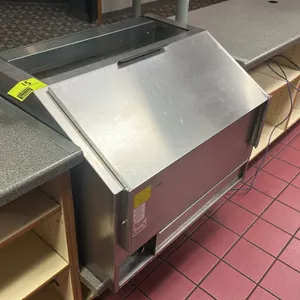 2012 Gold Medal 2344 36" drop-in commercial popcorn warmer. Features stainless steel construction, a perforated bottom deck, analog heat control dial,