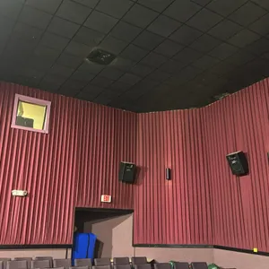 Movie theater wall-mounted sound curtains. Features a pleated fabric construction in burgundy. Designed for acoustic sound dampening. Note: Speakers, 