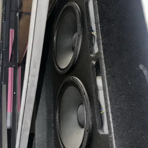 Commercial movie theater behind-screen speaker and subwoofer components. Includes a dual-driver subwoofer enclosure, a single-driver cabinet, and a ho