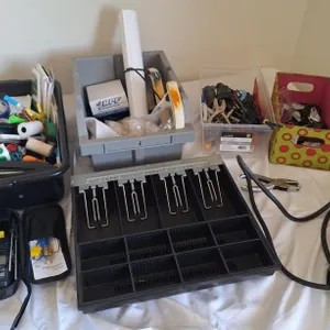 Office supplies, cash box, and assorted tools
