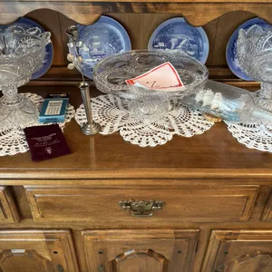 Plates and cut glass platters on shelf