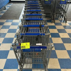Metal wire shopping carts. Features grey finish wire baskets, integrated child seating areas with safety straps, and blue plastic handle grips. Equipp