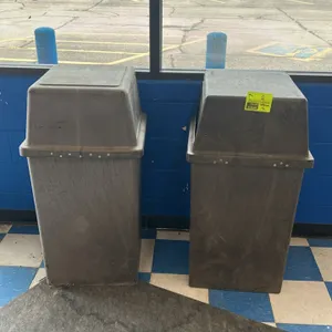 Polyethylene trash bins. Features molded plastic construction with a textured brown finish, and removable hooded lids with swing-open push doors.
