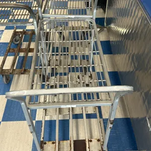 Metal 2-tier utility carts. Features a wire top shelf, slatted lower shelf, and an integrated push handle. 42"L. Mounted on casters. Note: Units exhib