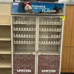 Metal 2-door tobacco merchandiser. Features sliding glass doors with a locking latch, interior adjustable shelves with spring-loaded product pushers, 