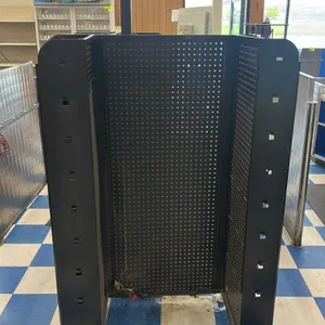 Portable candy and magazine display rack. Features black metal construction with pegboard back panels, wire shelves, peg hooks, and a top mounting bra