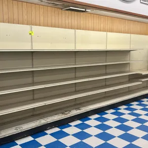 24'L of Lozier wall shelving. Features 84"H uprights with solid back panels, 22"D base shelves, and adjustable multi-tier upper shelves. Cream finish 