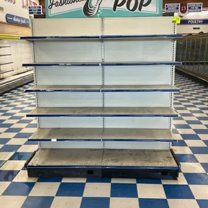 12'L of Lozier wall shelving. Features 77"H uprights, 22"D base shelves, and adjustable upper shelves with price tag molding. White finish. Signage an