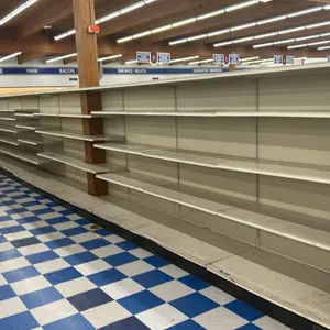 123'L of Lozier gondola shelving. Features 72"H uprights, 22"D base shelves, adjustable upper metal shelves, and pegboard backing. Contents not includ
