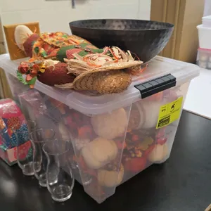 Holiday decor and family game lot. Includes a clear plastic lidded storage bin filled with faux autumn foliage, mini pumpkins, and gourds. Also includ
