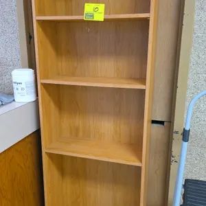 Laminate wood bookshelf. Features four storage compartments with three adjustable shelves and a matching woodgrain backing. 72"H. Background items not