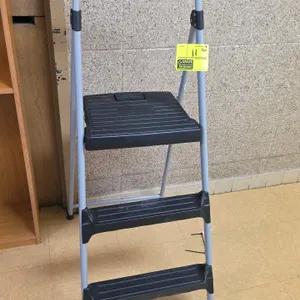 Cosco 3-step folding step stool. Features a gray steel frame, black plastic non-slip steps, and a high handrail with a textured grip.