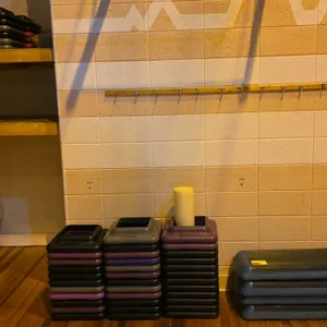 Quantity of poly exercise step platforms with height adjusters and a foam roller. Features blue rectangular step platforms with black textured slip-re