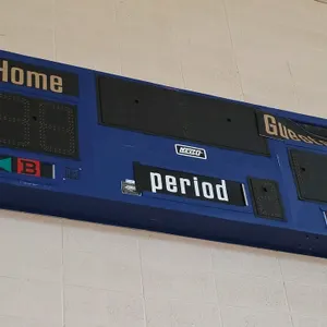Nevco LED scoreboard. Features Home and Guest score displays, period digit, and possession indicators. Blue metal housing. 80"L. Note: Controller is n
