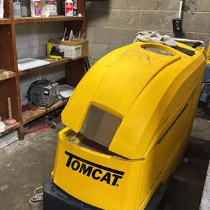 TomCat 2500 walk-behind floor scrubber. Includes a TomCat battery charger, squeegee assembly, and assorted cleaning supplies as shown. Note: Unit requ