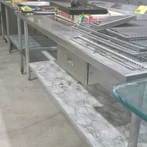 Stainless steel prep table. Features a rear backsplash, one utility drawer, and an undershelf. Dimensions: 84"x30"x40". Mounted on tubular legs with a