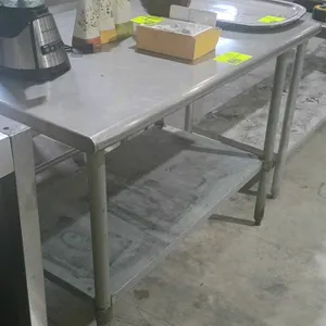 Stainless steel work table. Features an adjustable undershelf and tubular legs. Dimensions: 48"x30"x37". Contents not included.