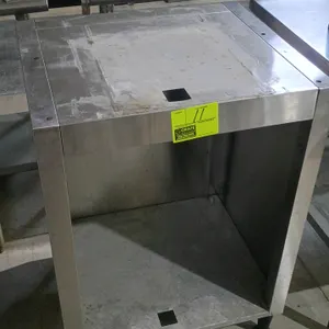 Stainless steel open front cabinet. Features a single open compartment with square cutouts on the top panel and bottom shelf. Dimensions: 26"x23"x36".