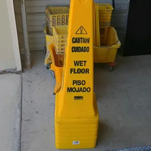 Rubbermaid wet floor safety cones. Features a stackable, four-sided design in high-visibility yellow plastic with bilingual 'Caution Wet Floor / Cuida
