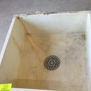Drain basin. Features molded composite construction with a central metal drain grate. 24"x24"x12".