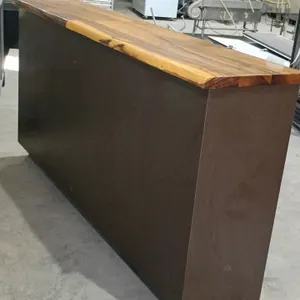 Checkout counter. Features a finished solid wood top, brown laminate exterior panels, and an open back design. Dimensions: 83"L x 18"W x 42"H. Note: S