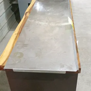 Stainless steel shelf. Features a raised rear lip and a front down-turn edge. Dimensions: 73"L x 15"W. Note: Mounting brackets are not included. Displ