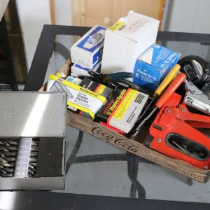 Large selection of hand tools including staplers, staples, wire strippers, chalk line, etc.
