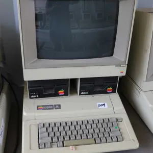 Vintage 1980s Apple IIE with two Apple Disk II disk drives and Apple Apple ColorMonitor IIe. See pho