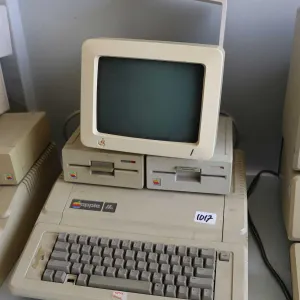 Vintage 1980s Apple IIE with two Apple Disk drives and Apple Monitor with stand. See photos for inte