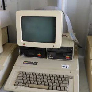 Vintage 1980s Apple IIE with two Apple Disk II disk drives and Apple Monitor with stand. See photos 