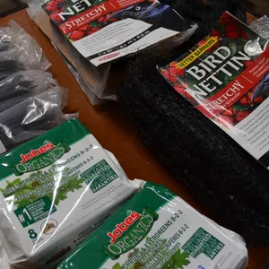 6 pkgs of Bird Netting, 5 pkgs Landscape Fabric Pegs, 2 pkgs of Organic Fertilizer
