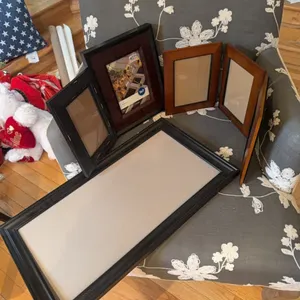 Various unused picture frames and tablecloth. also magazine rack.
