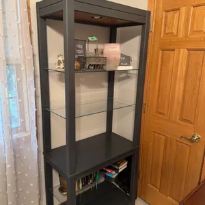 6 foot shelf, excellent quality, grey, has glass shelves and top light   Note:  Lot 48 is an exact match to this one. It was decided to sell them sepa