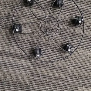 Metal Plant Caddy with Six Wheels and Decorative Circular Frame Design, Black Finish, Rolling Stand