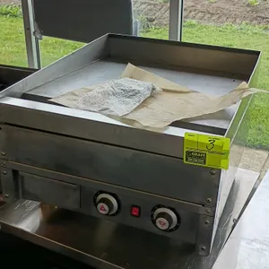 Stainless steel electric griddle. Features two manual dial controls and an on/off toggle switch. Dimensions: 24"x31"x19". Electric. Mounted on adjusta