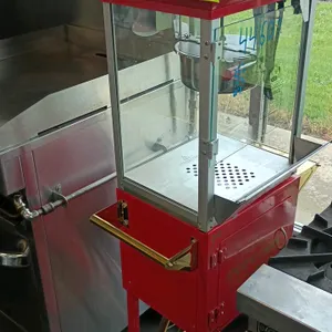 The Perfect Popper popcorn machine. Features a stainless steel kettle, glass viewing cabinet, three-switch control panel, and heated warming deck. Dim