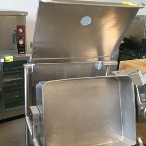 Groen Eclipse Ergonomic gas tilting braising pan. Features stainless steel construction, a manual tilt handwheel, and a hinged lid with a circular ven